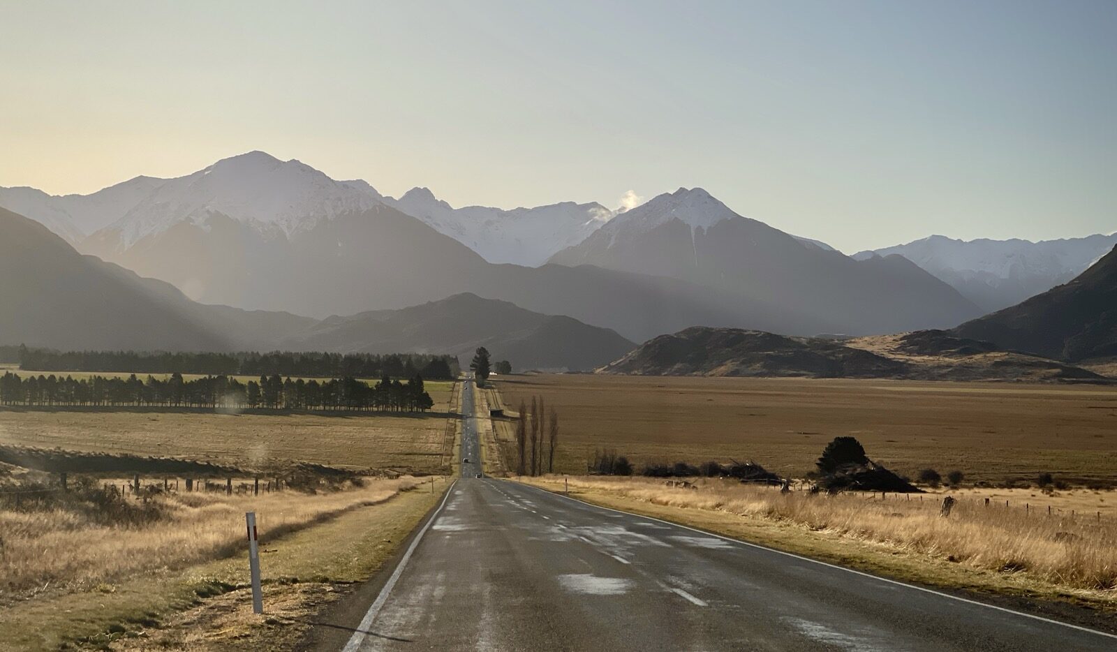 A straight road running to distant hills
