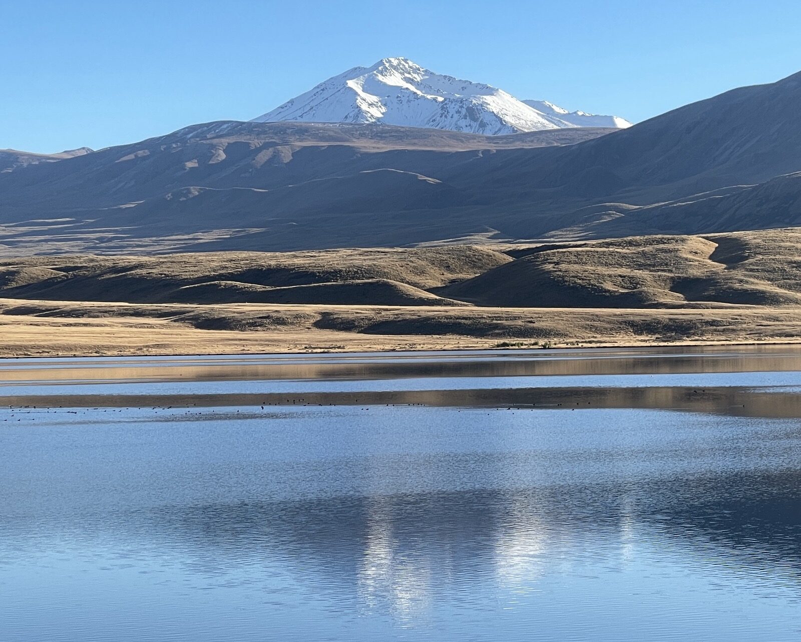 Snow mountains mirrored in a still lake